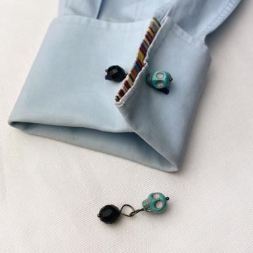 Skull cufflinks in tinted turquoises