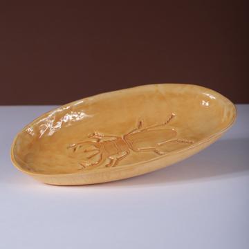 Scarabée dish in stamped earthenware, yellow orange [1]